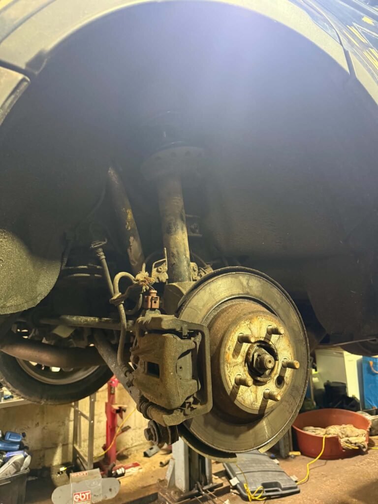 Brake disc and caliper inspection on a car serviced near Buxton