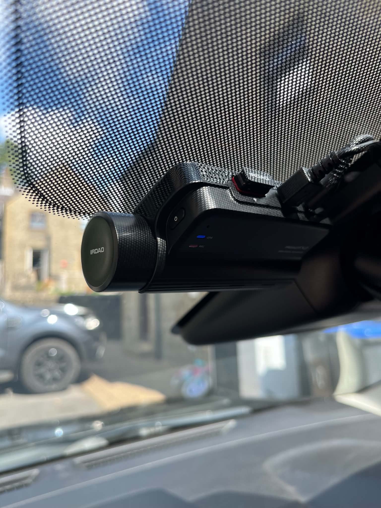 Discreet dashcam install tucked behind the mirror and out of the driver's eyeline