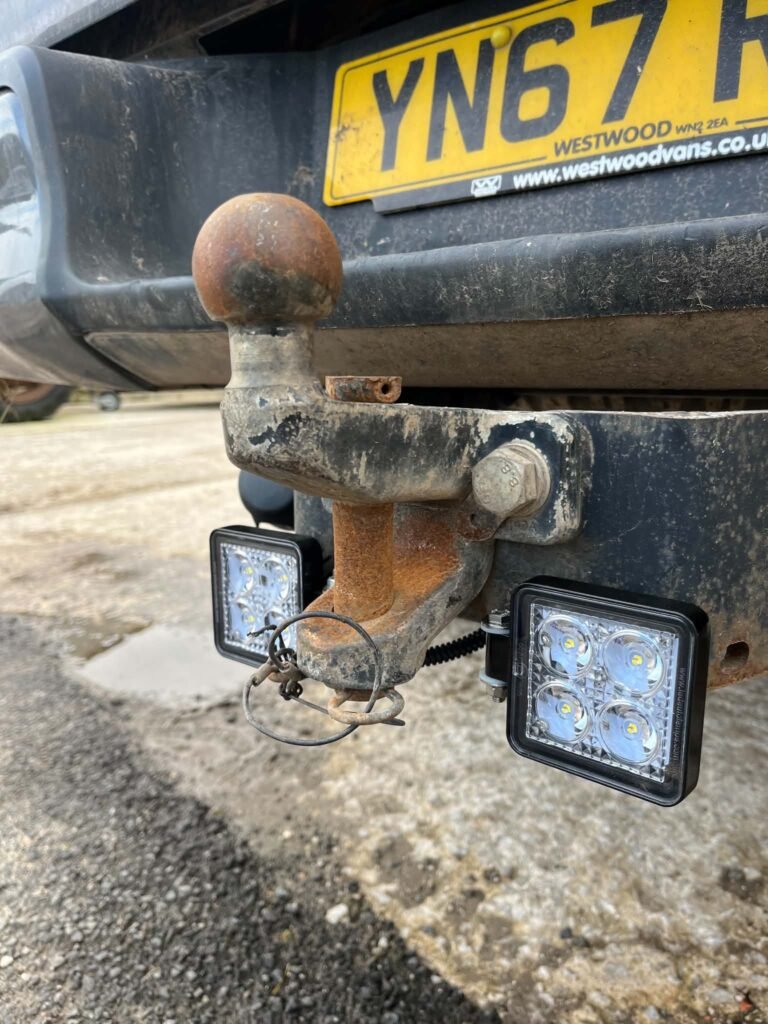 Rear work lamps fitted either side of a towbar on a pickup near Ashbourne