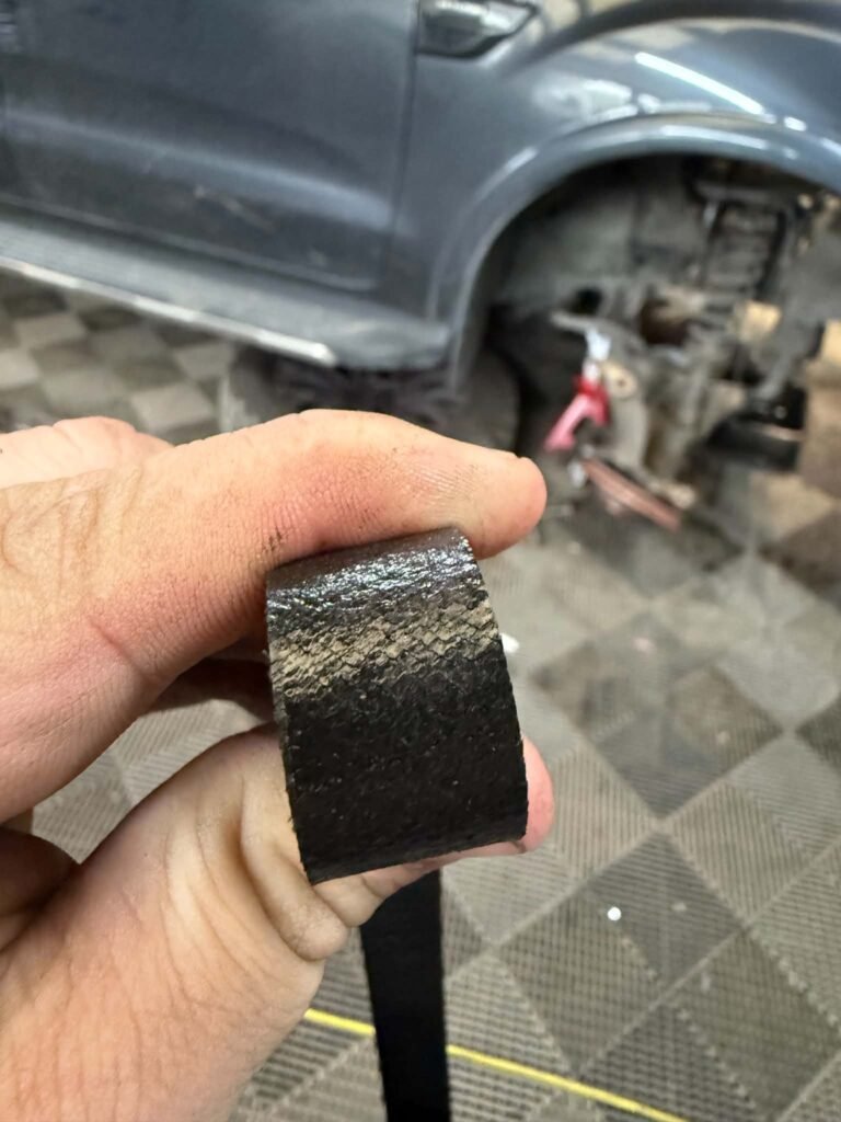 Worn drive belt removed from a vehicle serviced in Crewe